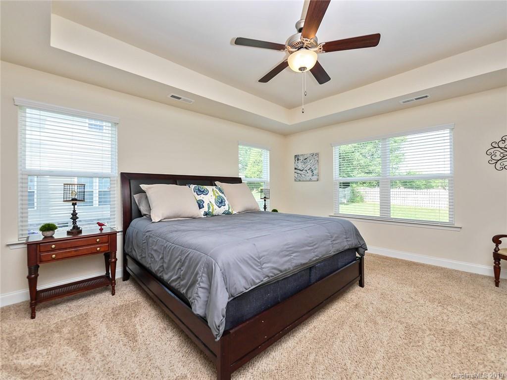 7817 Pope Farm Road Charlotte, NC 28269 - Photo 14 of 26 a bedroom with a bed chandelier and a large window