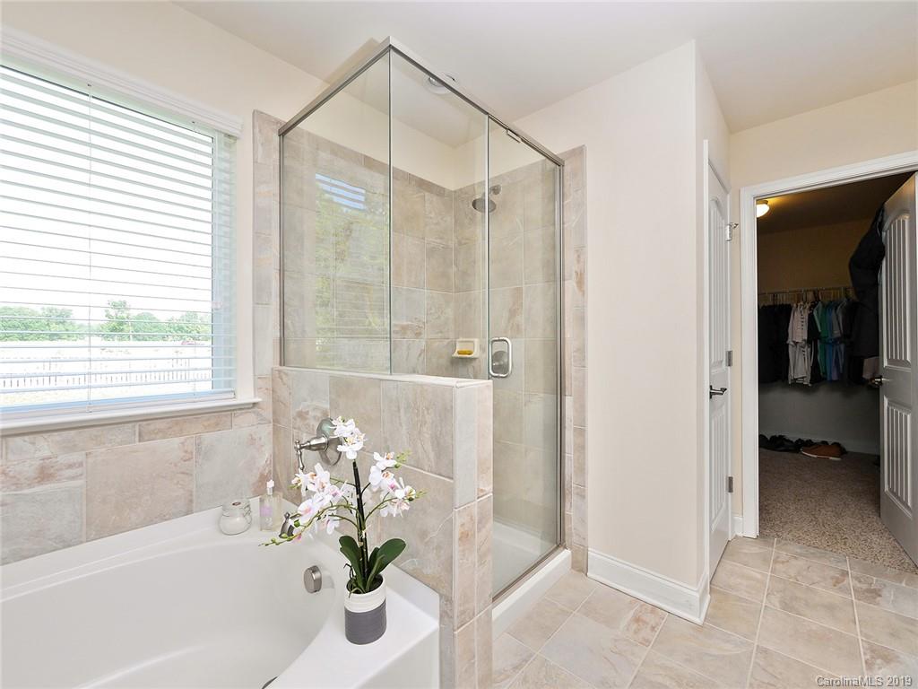 7817 Pope Farm Road Charlotte, NC 28269 - Photo 16 of 26 a bath room with a bathtub and a shower