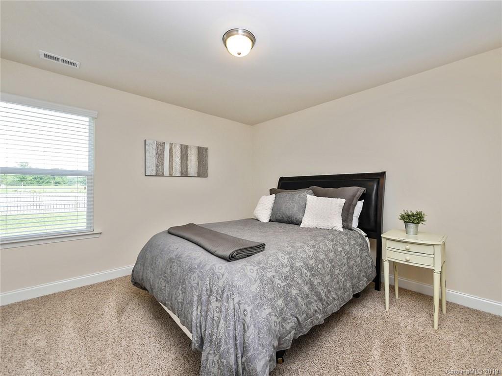 7817 Pope Farm Road Charlotte, NC 28269 - Photo 17 of 26 a bedroom with a bed and window