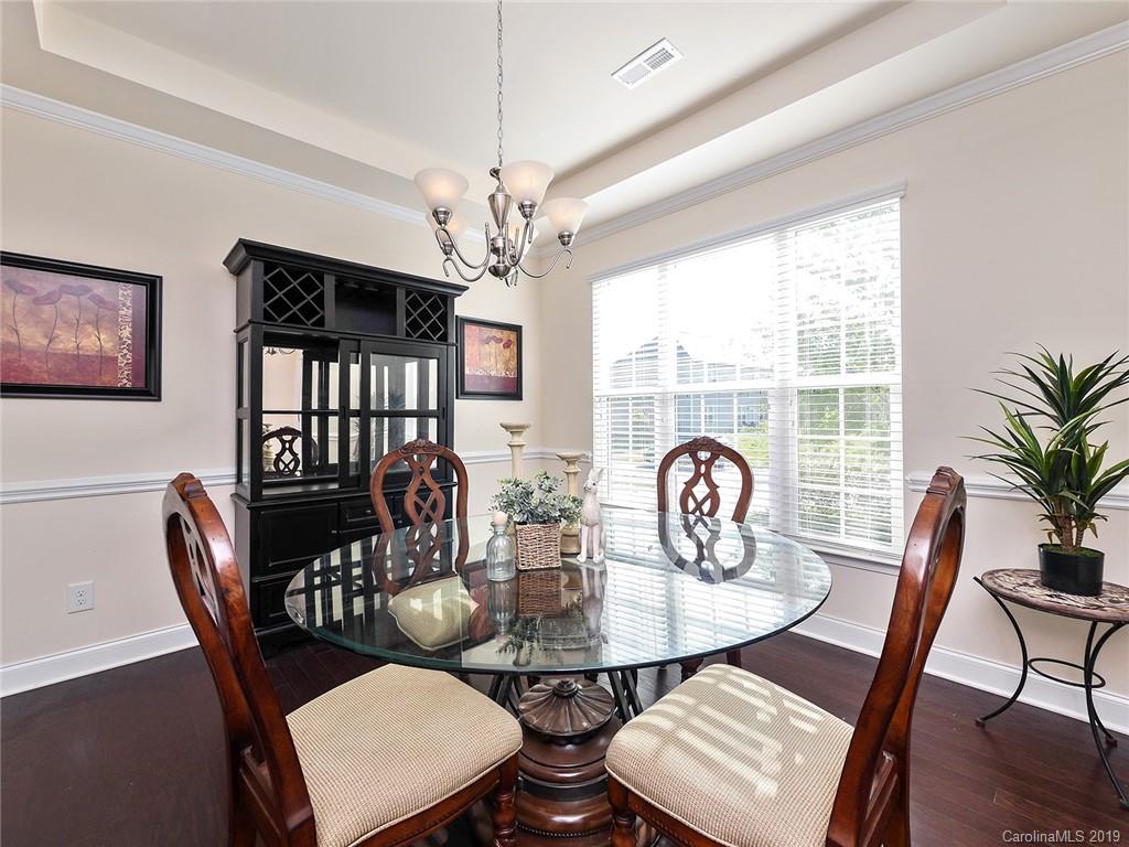 7817 Pope Farm Road Charlotte, NC 28269 - Photo 3 of 26 a view of a dining room with furniture window and wooden floor