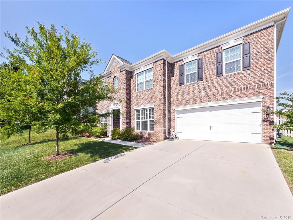 7817 Pope Farm Road Charlotte, NC 28269 - Photo 26 of 26 a front view of a house with a yard and a garage