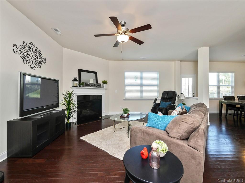 7817 Pope Farm Road Charlotte, NC 28269 - Photo 6 of 26 a living room with furniture a fireplace and a flat screen tv