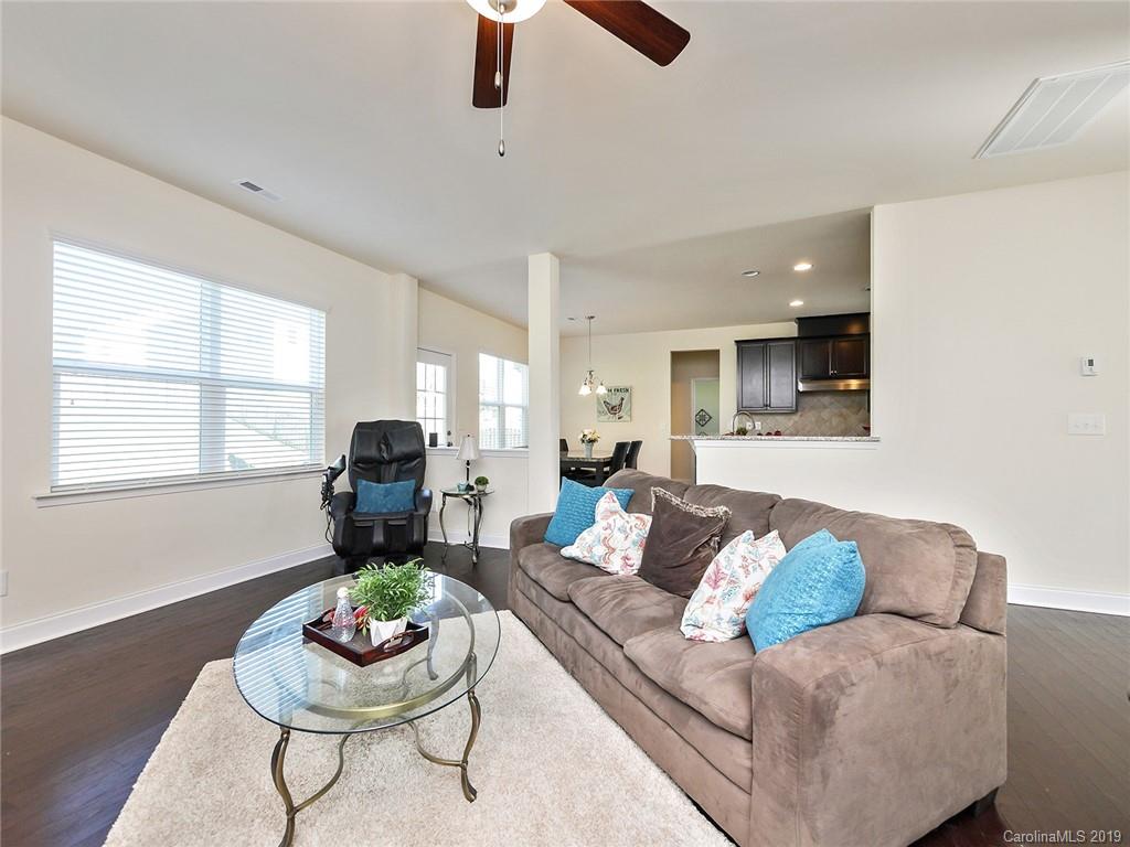 7817 Pope Farm Road Charlotte, NC 28269 - Photo 7 of 26 a living room with furniture and a wooden floor