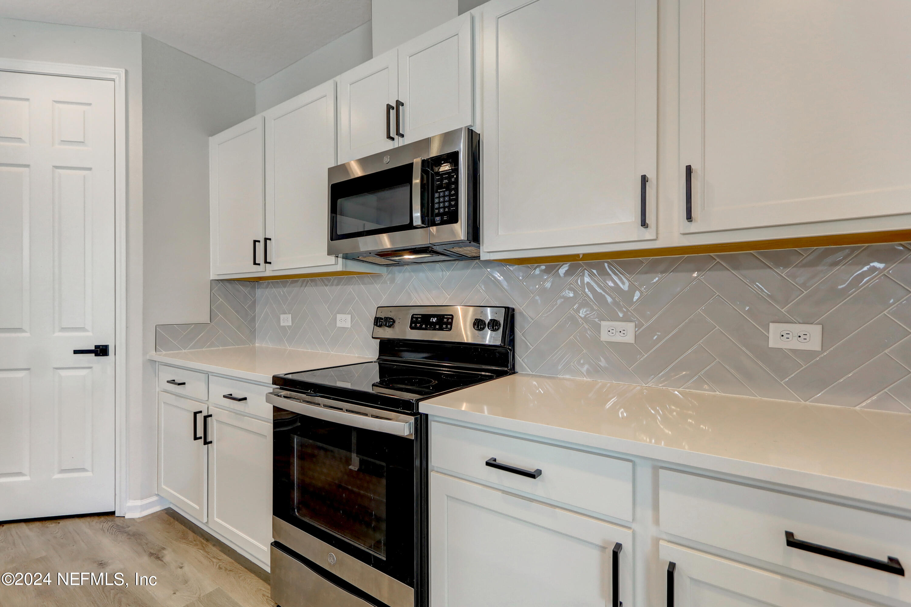 1880 Cogdill Trace Middleburg, FL 32068 - Photo 11 of 40 a kitchen with white cabinets and appliances