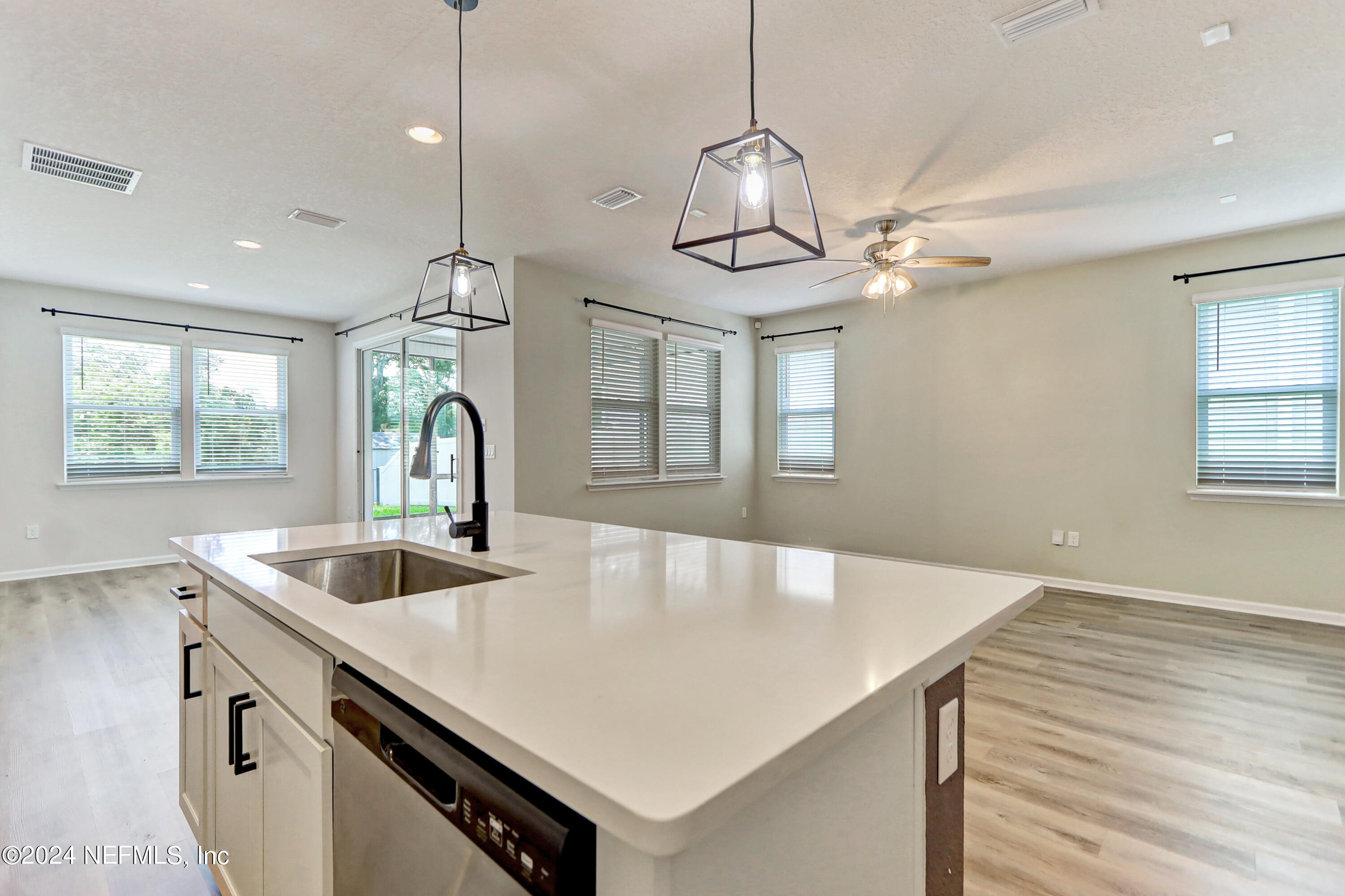 1880 Cogdill Trace Middleburg, FL 32068 - Photo 15 of 40 a kitchen with stainless steel appliances granite countertop a sink a center island and windows