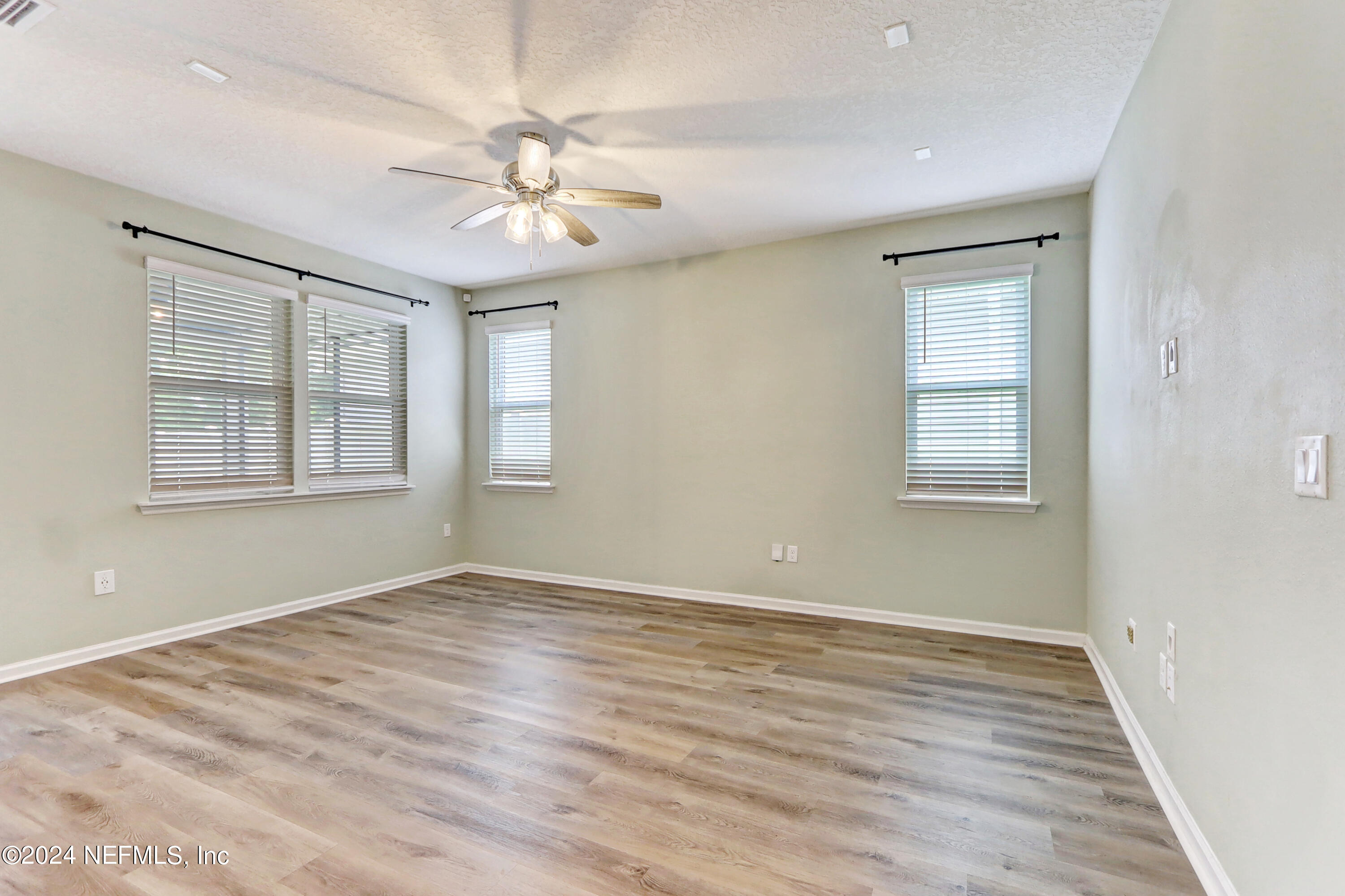 1880 Cogdill Trace Middleburg, FL 32068 - Photo 16 of 40 a view of an empty room with wooden floor and a window
