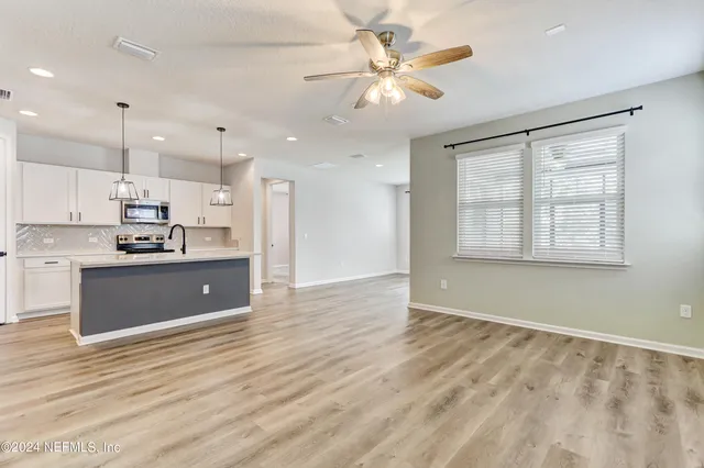 a view of kitchen with window and stainless steel appliances
