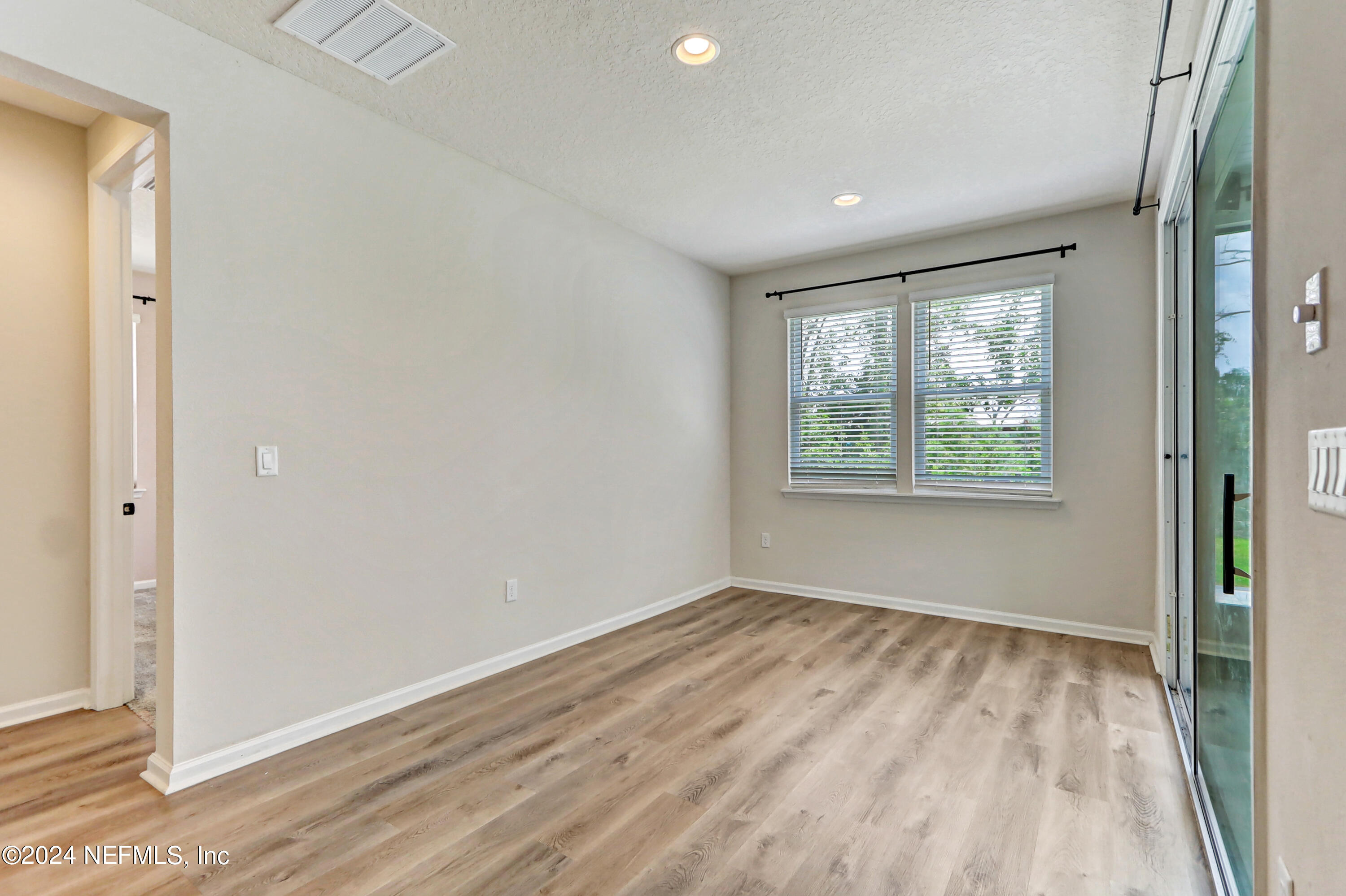 1880 Cogdill Trace Middleburg, FL 32068 - Photo 20 of 40 an empty room with wooden floor and windows