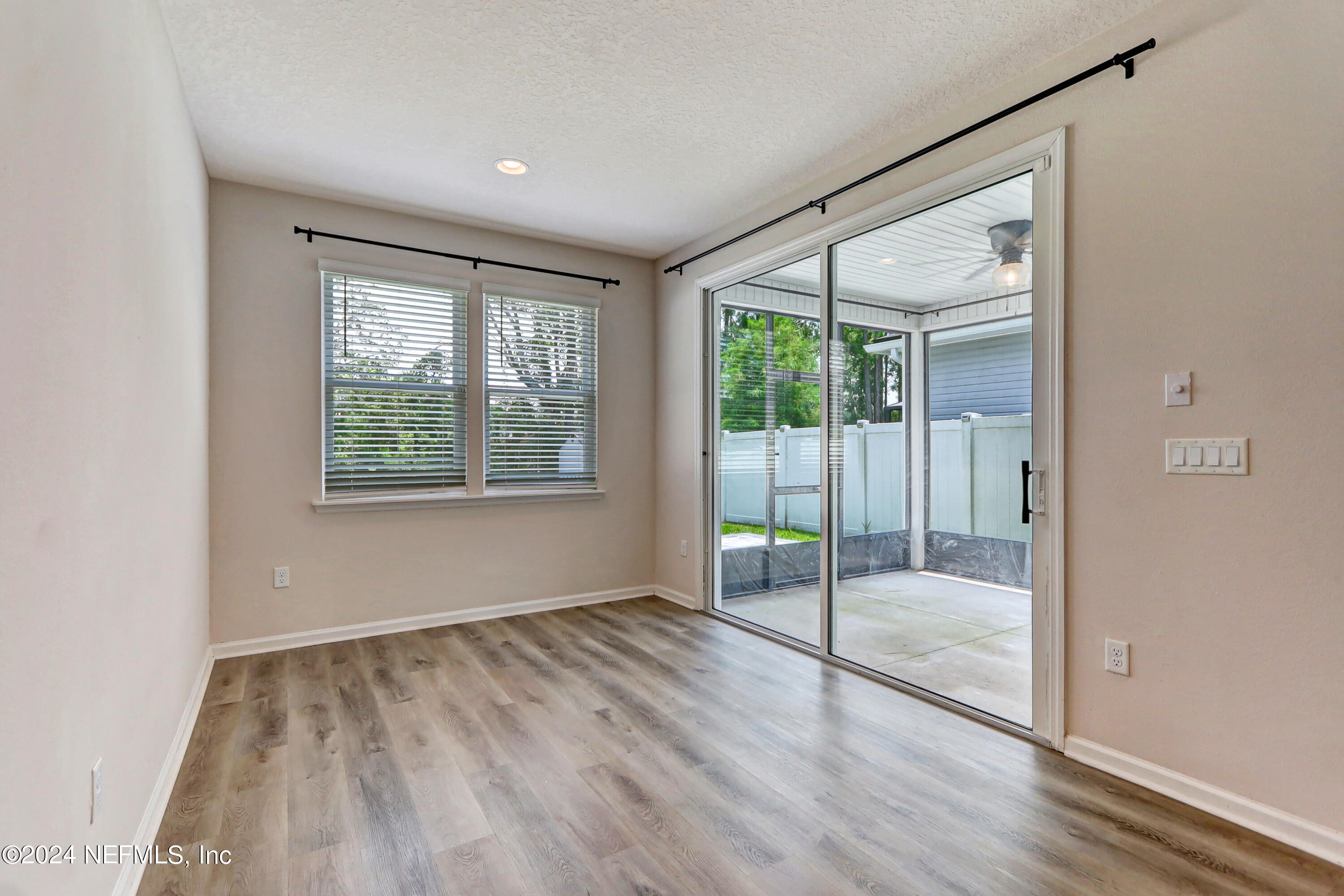 1880 Cogdill Trace Middleburg, FL 32068 - Photo 21 of 40 an empty room with wooden floor and windows