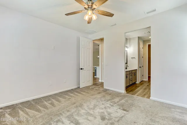 a view of a livingroom with a chandelier fan