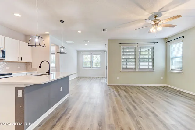 a view of a kitchen with a sink and windows