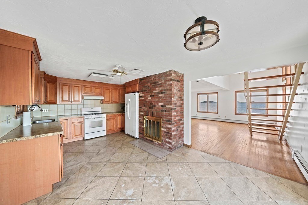 212 Nantasket Road Hull, MA 02045 - Photo 15 of 36 a view of a kitchen with furniture and a fireplace