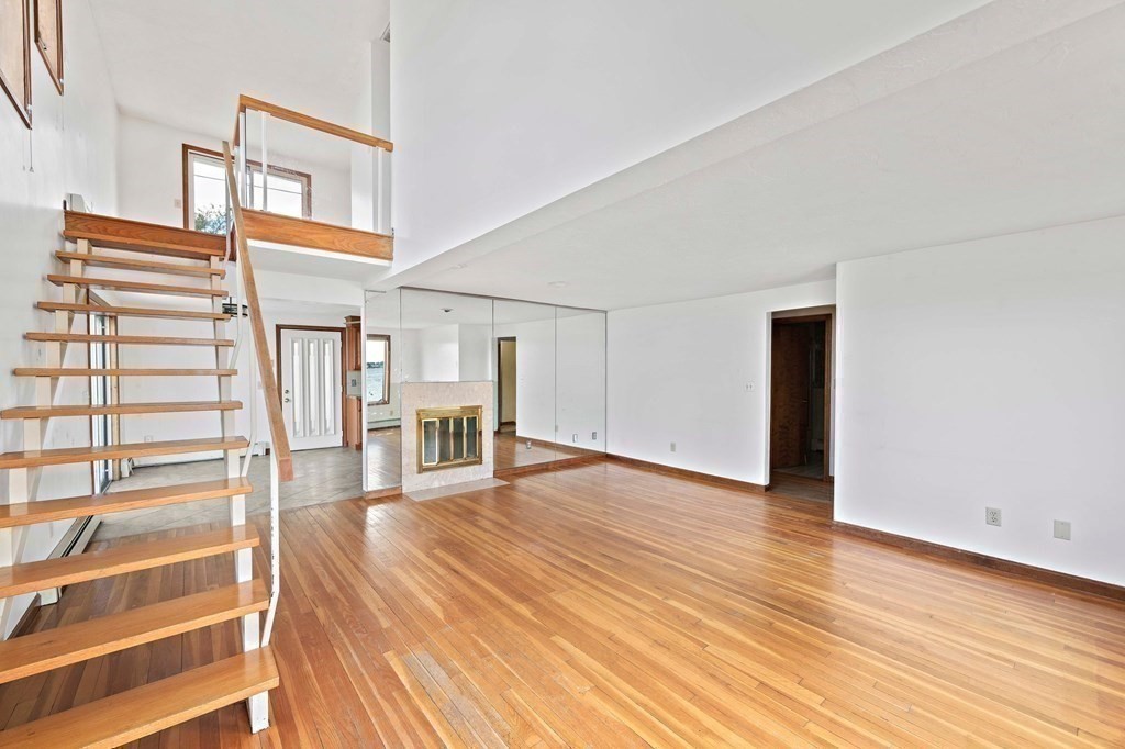 212 Nantasket Road Hull, MA 02045 - Photo 18 of 36 a view of an empty room with wooden floor and a window