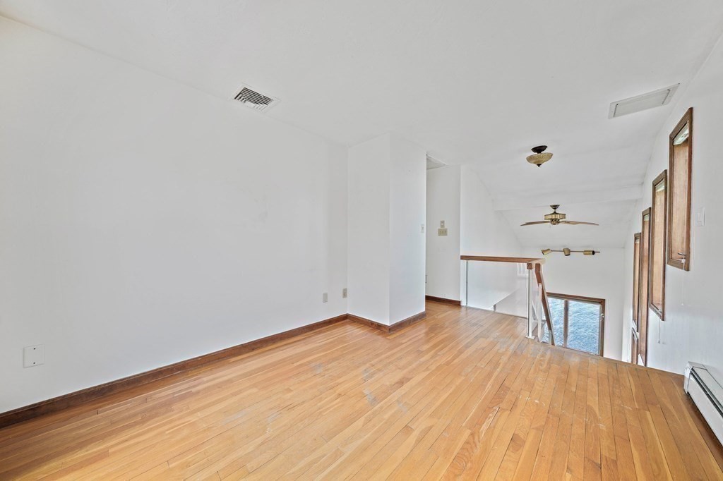 212 Nantasket Road Hull, MA 02045 - Photo 20 of 36 a workspace with wooden floor and windows