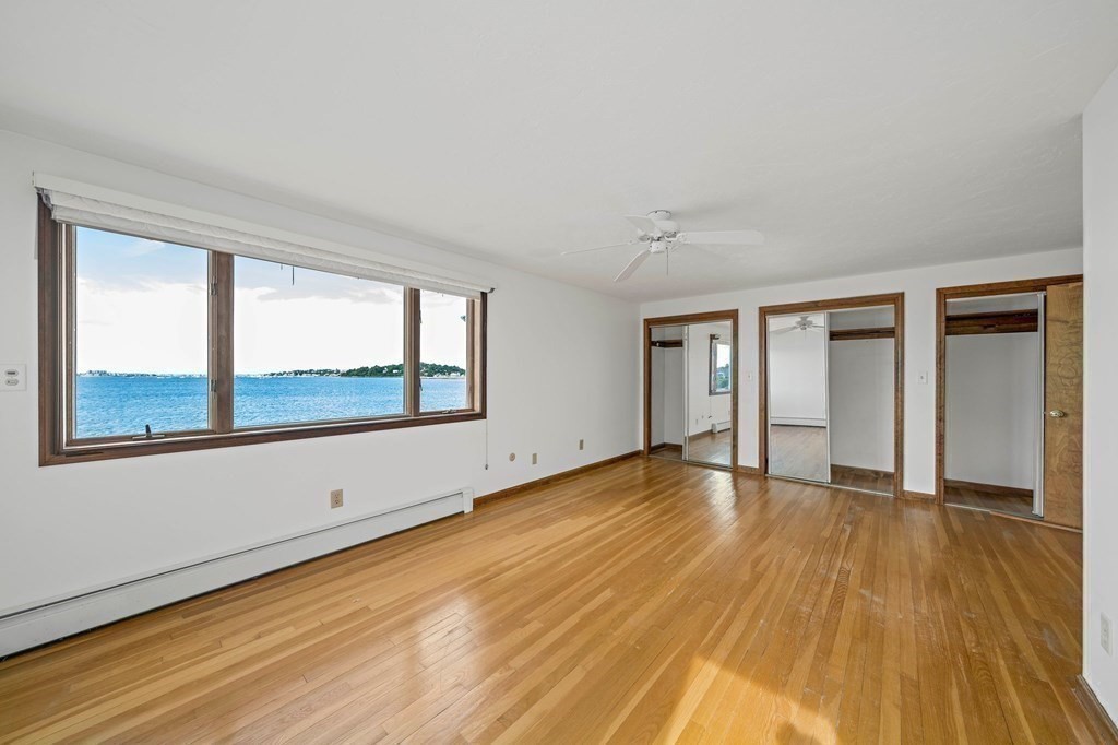 212 Nantasket Road Hull, MA 02045 - Photo 21 of 36 a view of an empty room with wooden floor and a window