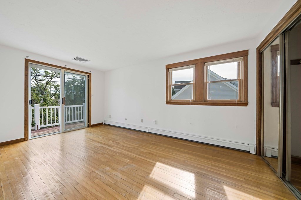 212 Nantasket Road Hull, MA 02045 - Photo 23 of 36 a view of an empty room with wooden floor and a window
