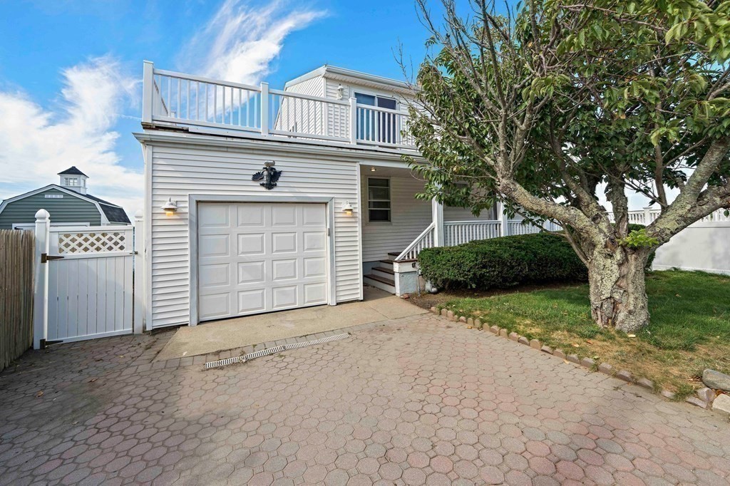 212 Nantasket Road Hull, MA 02045 - Photo 9 of 36 a front view of a house with a yard and garage