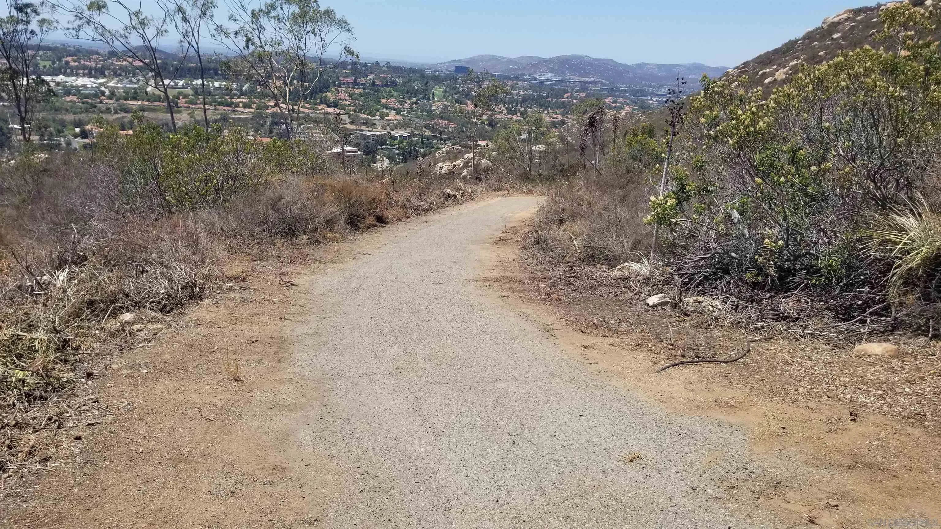12526 Southwest Boulder Mt Road, Unit 1 2 3 Poway, CA 92064 - Photo 16 of 16 a view of a dry field with trees in the background