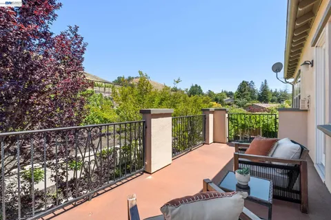 a view of a patio with table and chairs and potted plants