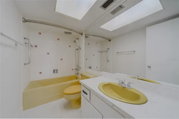 a bathroom with a sink a window and a bathtub