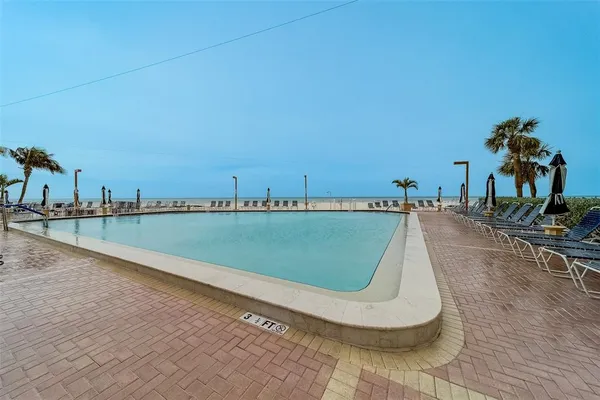 a view of a swimming pool with a yard