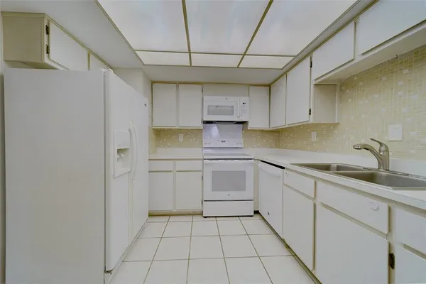 a kitchen with a sink cabinets and appliances