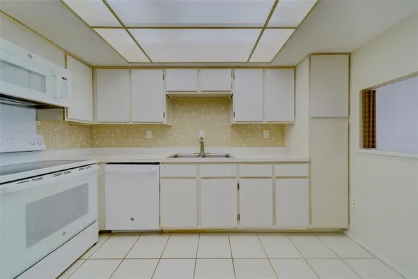 a kitchen with white cabinets