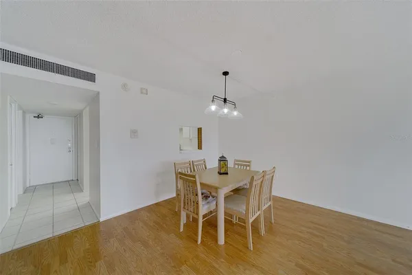 a view of a dining room with furniture and wooden floor