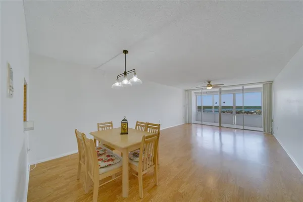 a view of a dining room with furniture and wooden floor