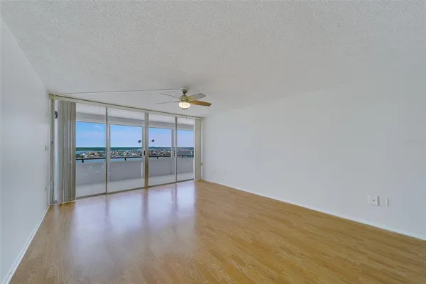 a view of a kitchen with a sink and dishwasher with wooden floor
