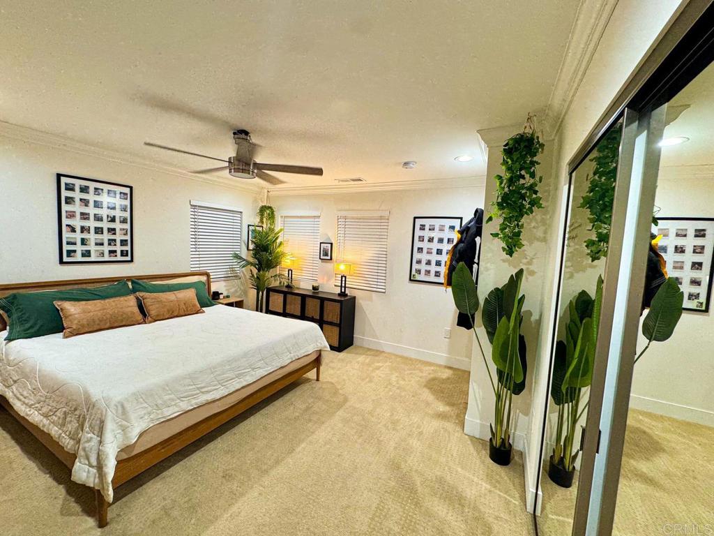 2687 Littleton Road El Cajon, CA 92020 - Photo 14 of 24 a bedroom with a bed potted plant and a large mirror