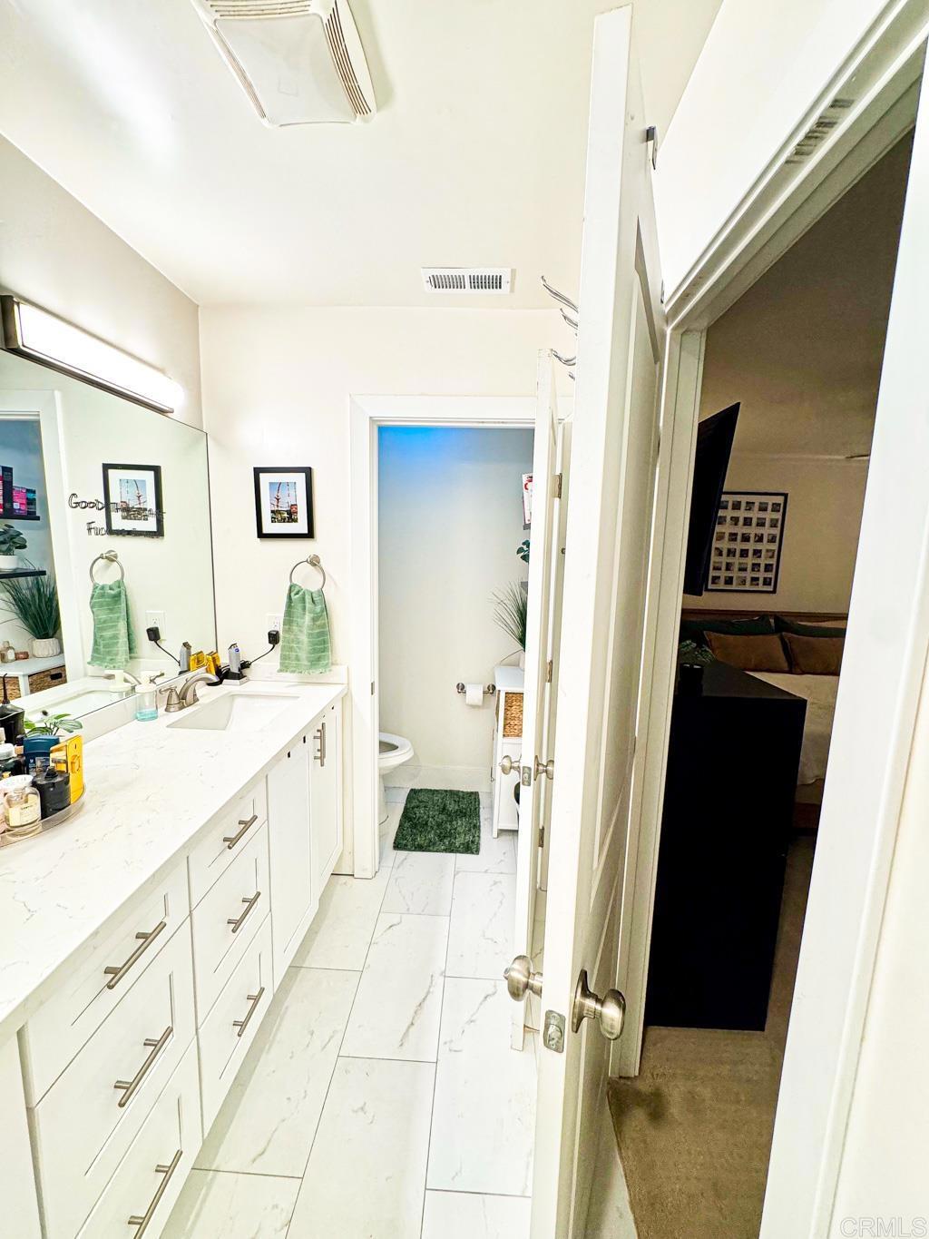 2687 Littleton Road El Cajon, CA 92020 - Photo 15 of 24 a bathroom with a double vanity sink and mirror