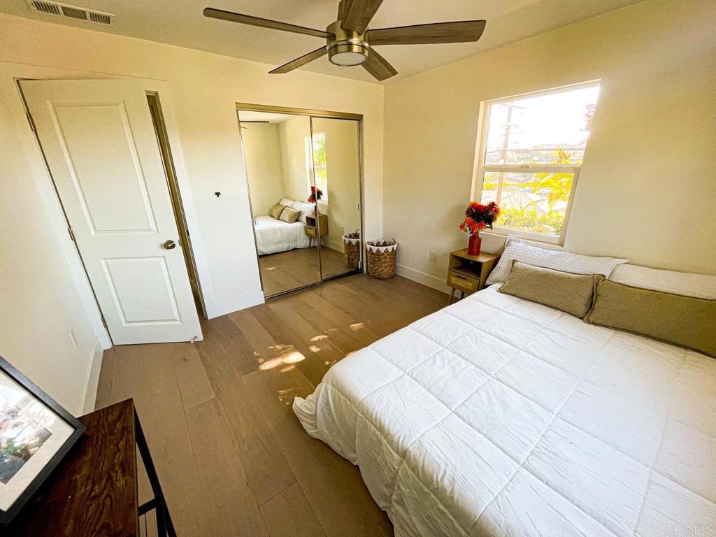 2687 Littleton Road El Cajon, CA 92020 - Photo 24 of 24 a bedroom with a bed and a large mirror next to a window