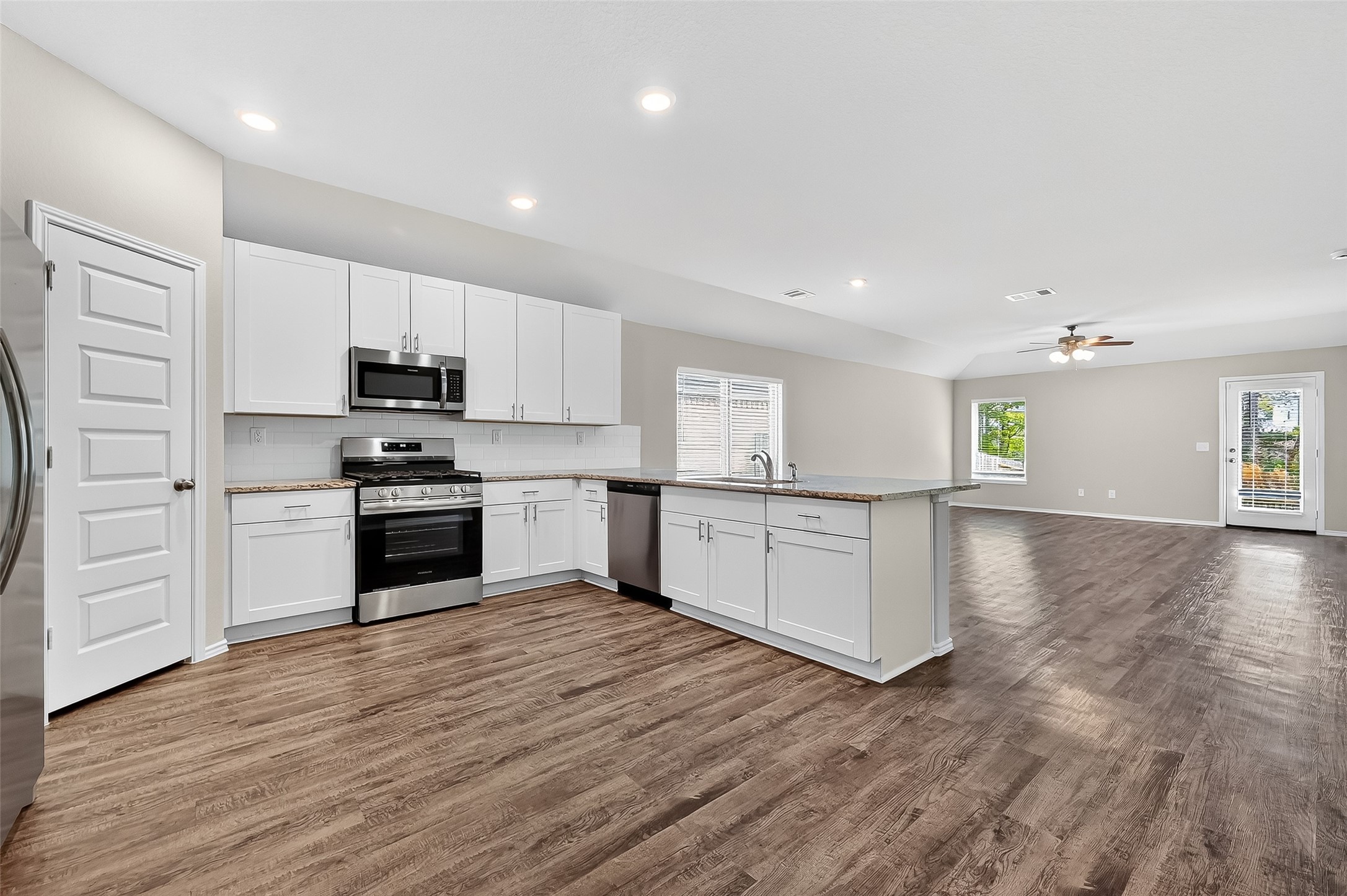 79 Courageous Way Magnolia, TX 77355 - Photo 3 of 23 a kitchen with white cabinets and appliances