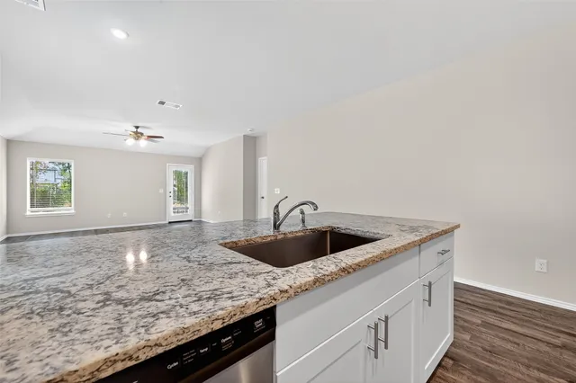a kitchen with a sink and cabinets