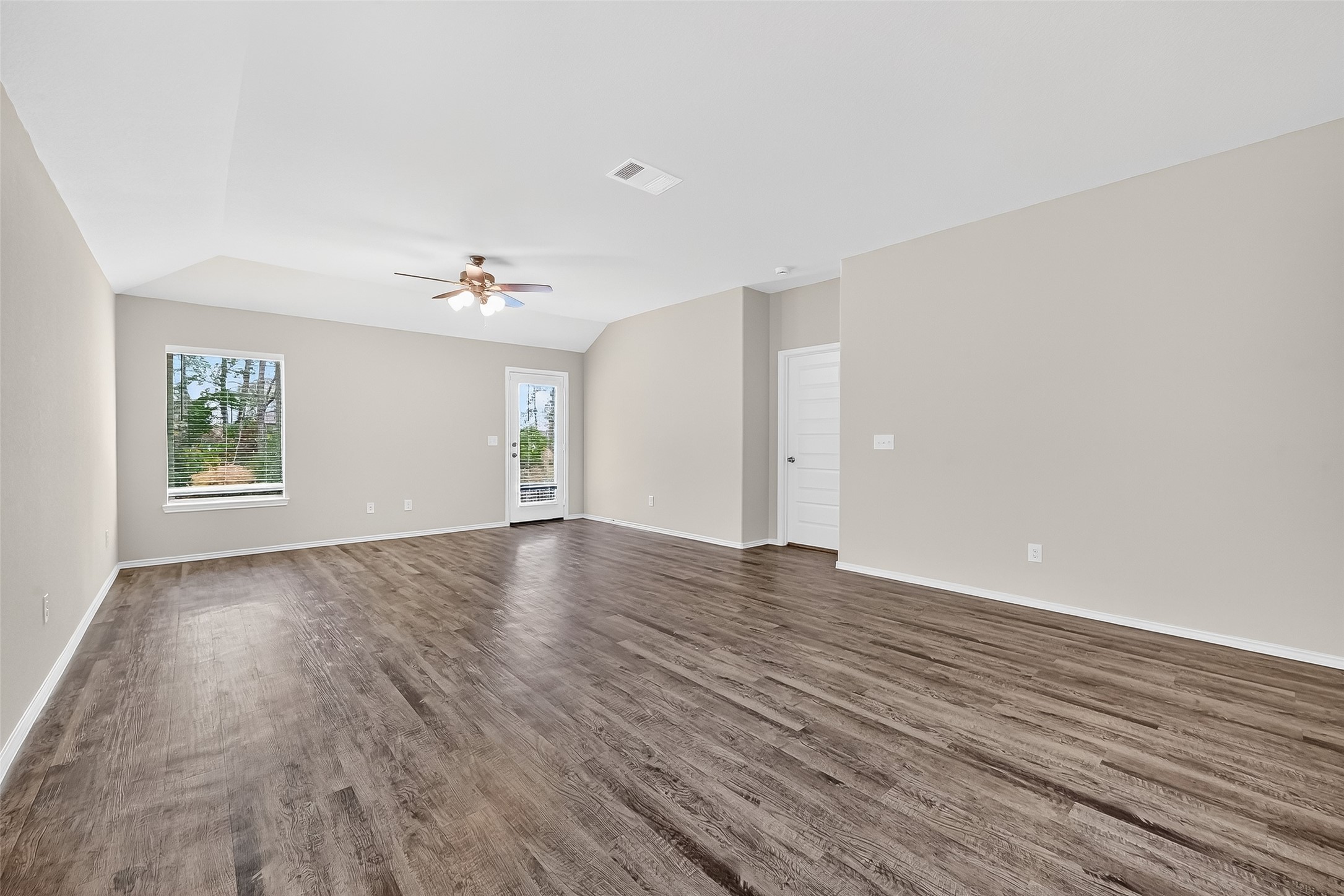 79 Courageous Way Magnolia, TX 77355 - Photo 7 of 23 an empty room with wooden floor and windows