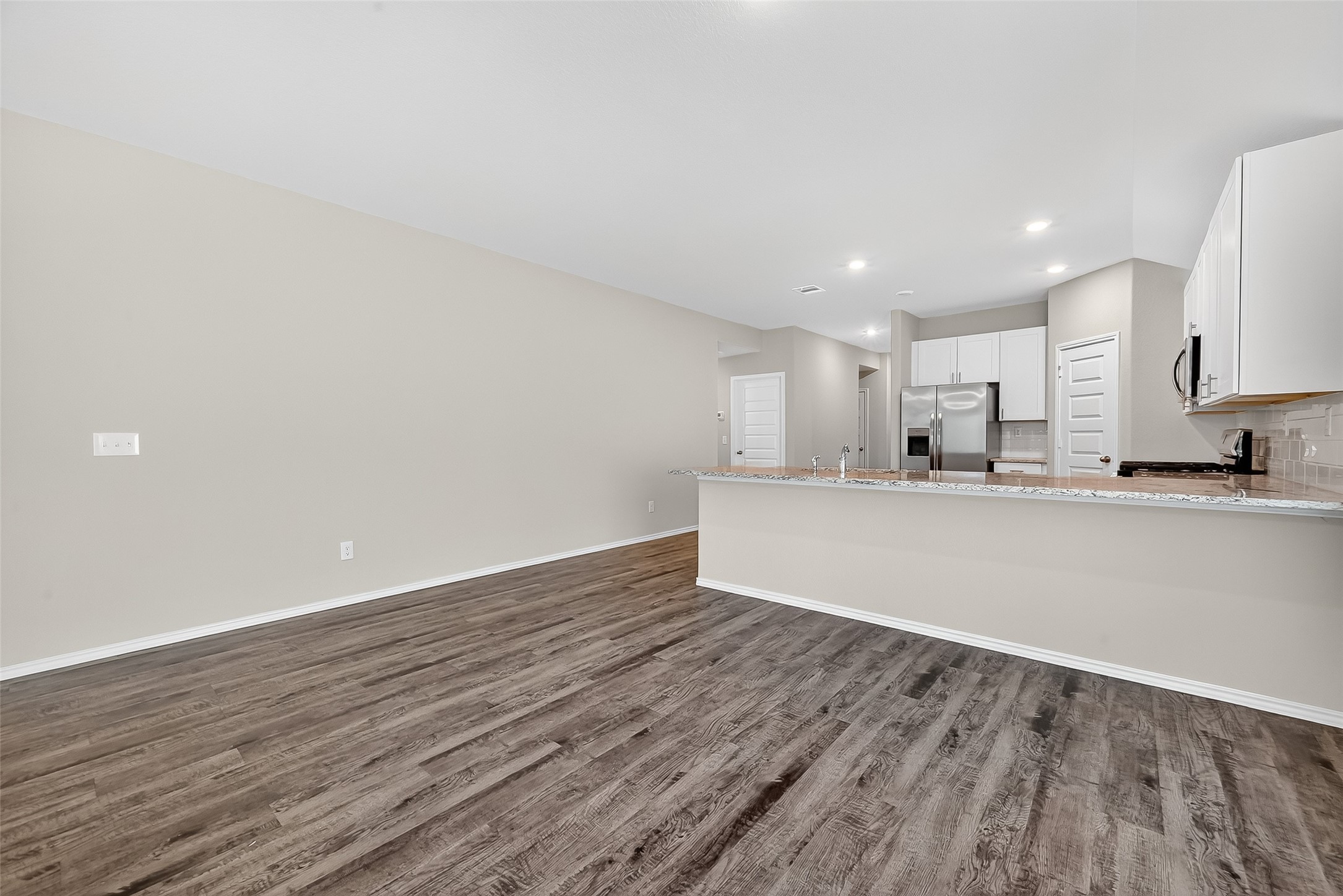 79 Courageous Way Magnolia, TX 77355 - Photo 8 of 23 a view of a kitchen with wooden floor and electronic appliances