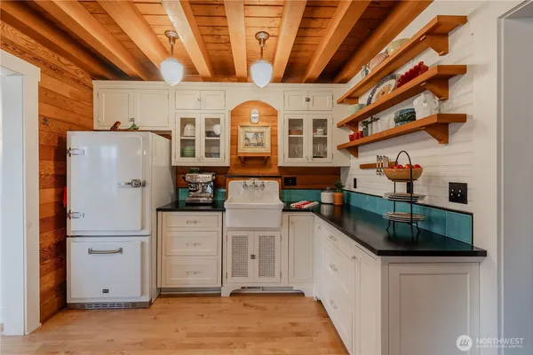 a kitchen with stainless steel appliances granite countertop a refrigerator a stove and a sink