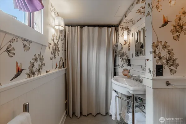 a bathroom with a sink vanity and a mirror