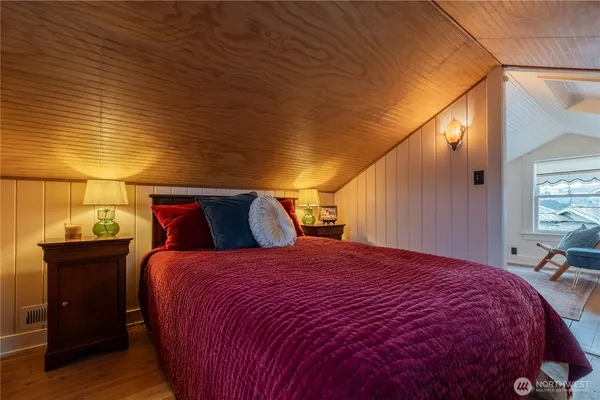 a bed sitting in a bedroom next to a window