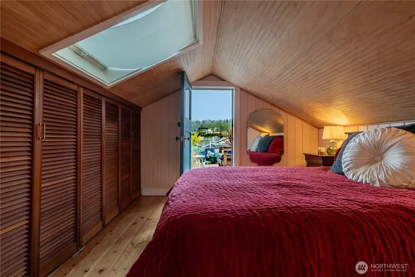 a bed sitting in a bedroom next to a window
