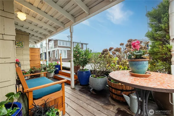 a outdoor dining space with furniture and potted plants