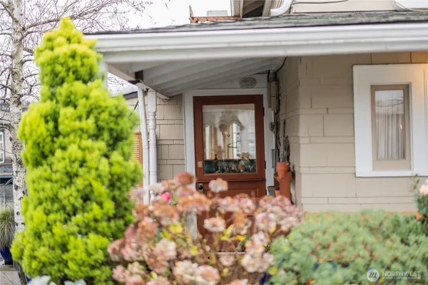 a front view of a house with outdoor seating and plants