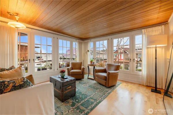 a living room with furniture and large windows