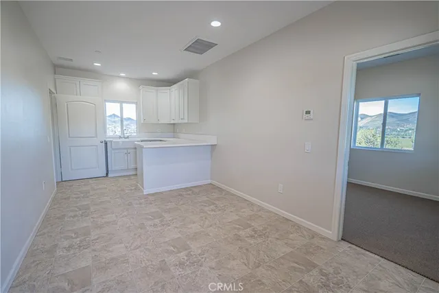 a kitchen with white cabinets