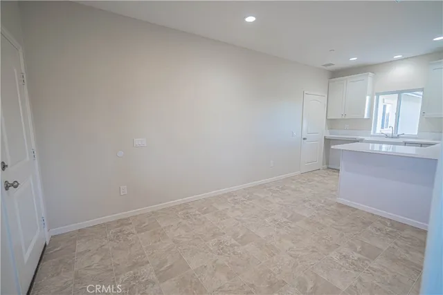 a kitchen that has a sink and a stove in it