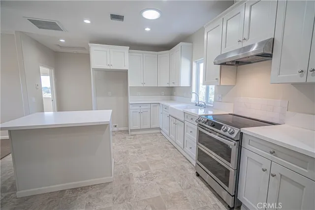 a bathroom with a tub a sink and a window