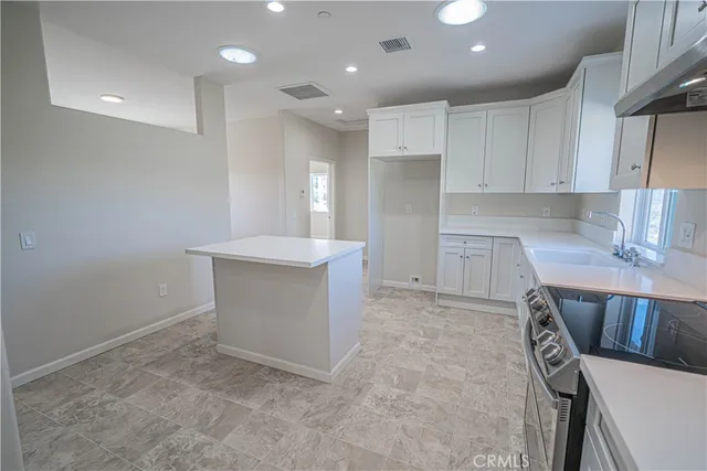 a kitchen with cabinets appliances and a sink