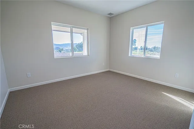 a spacious bathroom with a toilet sink and mirror