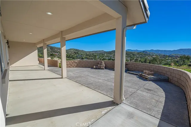 a view of a lush green forest with mountains in the background